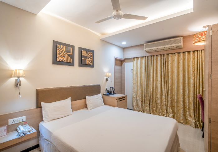 Deluxe room with cream walls and framed art