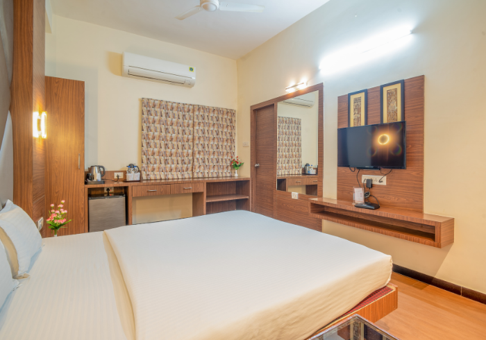 Deluxe double room interior with TV and desk