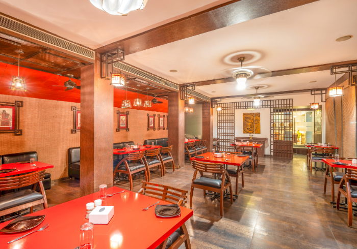 Kitty party seating with red tables at Hotel Varun