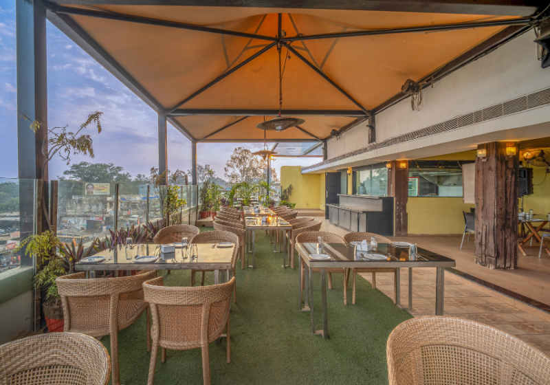 Rooftop dining area with greenery at The Terrace Grill