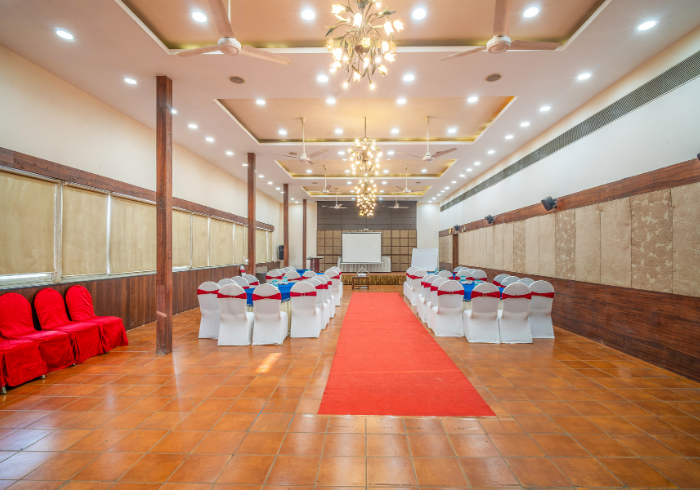 Orion hall with chandeliers, red carpet and stage area