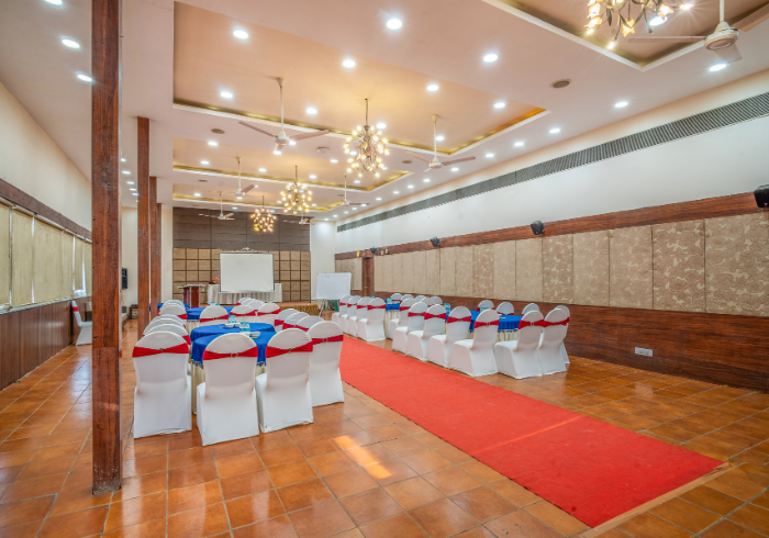 Orion marriage hall with decorated chairs and round tables